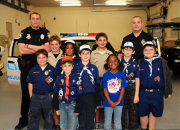 Wellington Cubscout Den 7 of Pack 125 are all smiles as they get the full tour from Sgt. Chris Oh and Officer Joe Esposito at the Light House Point Police Station in Light House Point Florida.