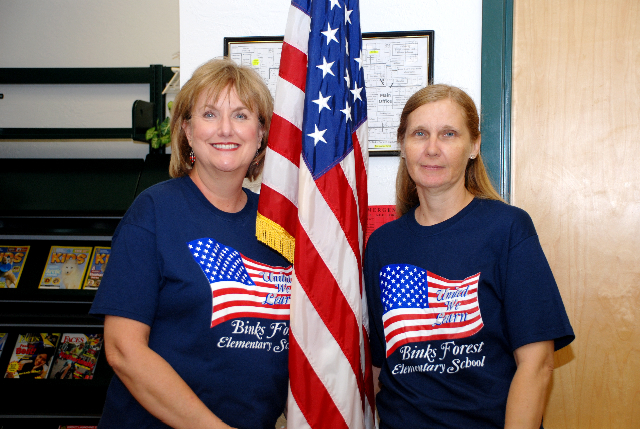 Media Clerk Shirley Houlihan and parent Sylvia Prochilo give a proud patriotic pose during the recent Patriot Day Celebration at Binks Forest Elementary.