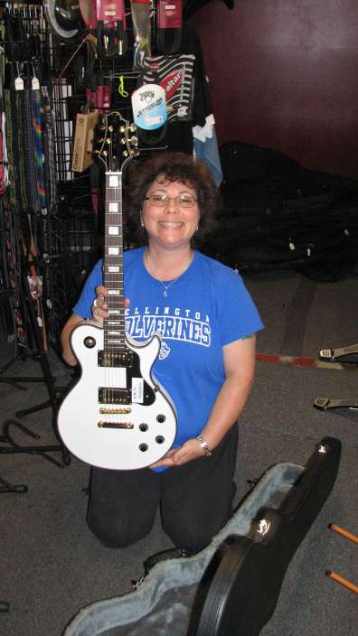 Melody Stuart of Boomer's Music and The Laura Brooke Music Foundation prepares to present a surprise guitar (a Les Paul replica) to honor "super-achiever" student Alex Rodriguez on his 9th birthday, on behalf of the Laura Brooke Music Foundation. www.passthedream.org