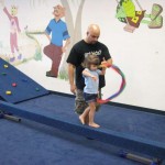 Walking on the balance beam and twirling a ribbon