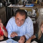 Tito teaching art to two young students
