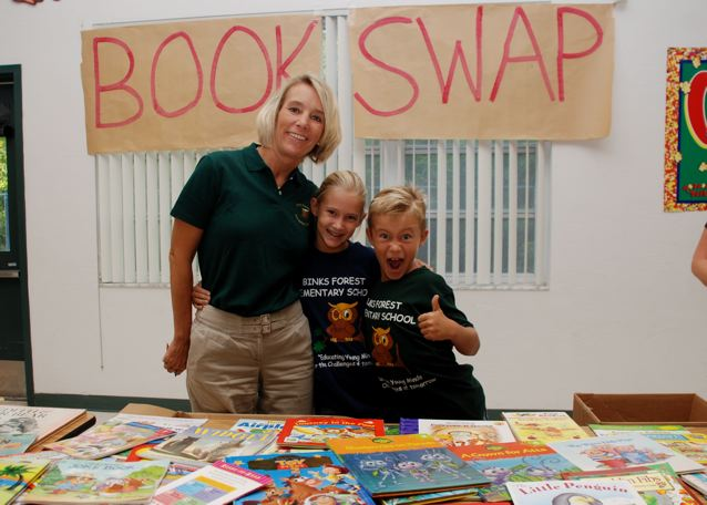Parent volunteer Lisa Weger with daughter and son Brittany and Blake who helped fellow Binks students trade books during the event.