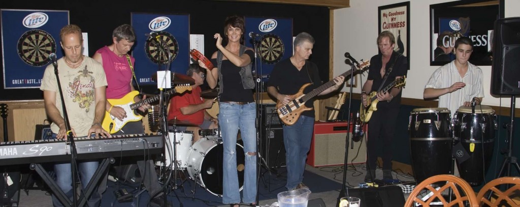 The Other Side band members perform in November of 2009