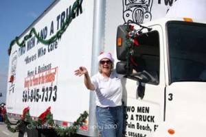 Janelle Dowley on the Two Men and a Truck float in the PW Chamber's Holiday Parade. Photo by Christine Rose.