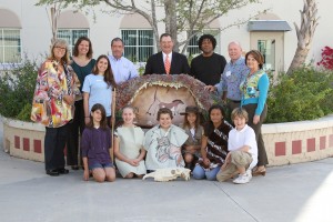 (Standing, L-R) Jean Hart-Howard, CCE artist; Kate Arrizza, SFSM Director of Education; Sara Bogotch, SFSM educator;  Shawn Berry, CCE program director; Lew Crampton, SFSM CEO;  Tim Mitchell, CCE artist; Dave Tripp, CCE artist; Sharon Stevens, Palm Beach Public principal and after-school coordinator. (Sitting, L-R) Kayla Blake, 5th grade; Madison Payne, 5th; Maico Gonzalez, 4th; Bianca Rosendahl, 4th; Jubilee Baquerizo, 5th; Cameron Owens,5th. 