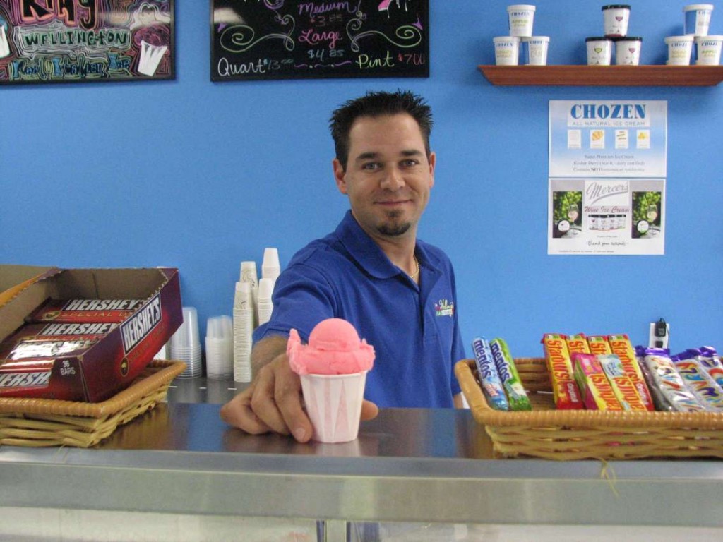 Michael Liberta serves up a cotton candy frozen ice at The Ice King of Wellington.