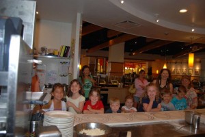 Lining up at the counter to make pizzas.