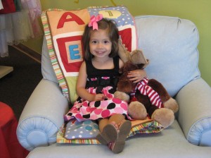 Valentina models the LadyBugs clothing and trys out a comfy chair, also for sale.